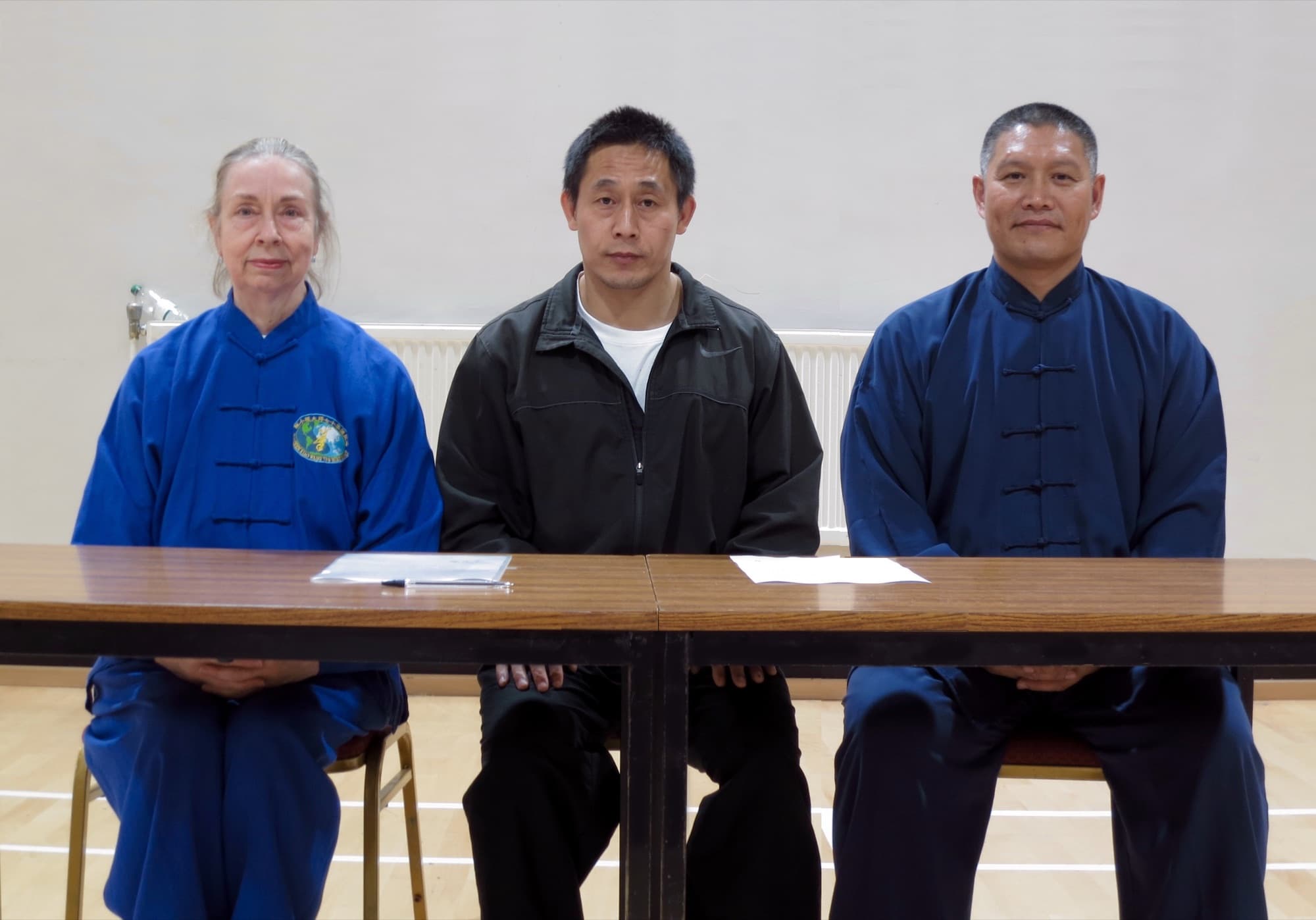 Chris Jones, Chen Ziqiang and Shifu Liu seated side by side at a table, 2017