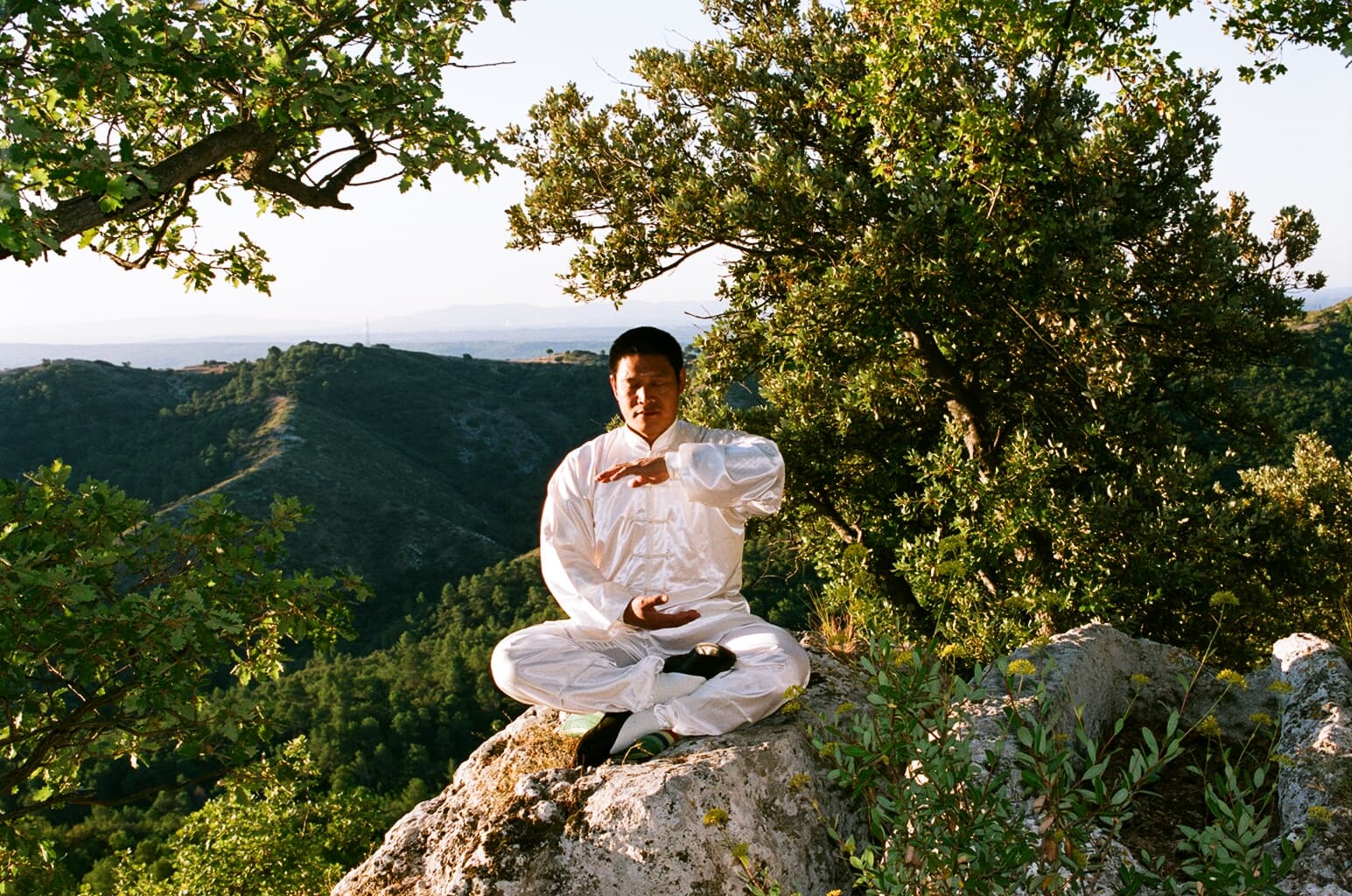 Shifu Liu meditating on a rock during Da Bei training in France, 2007