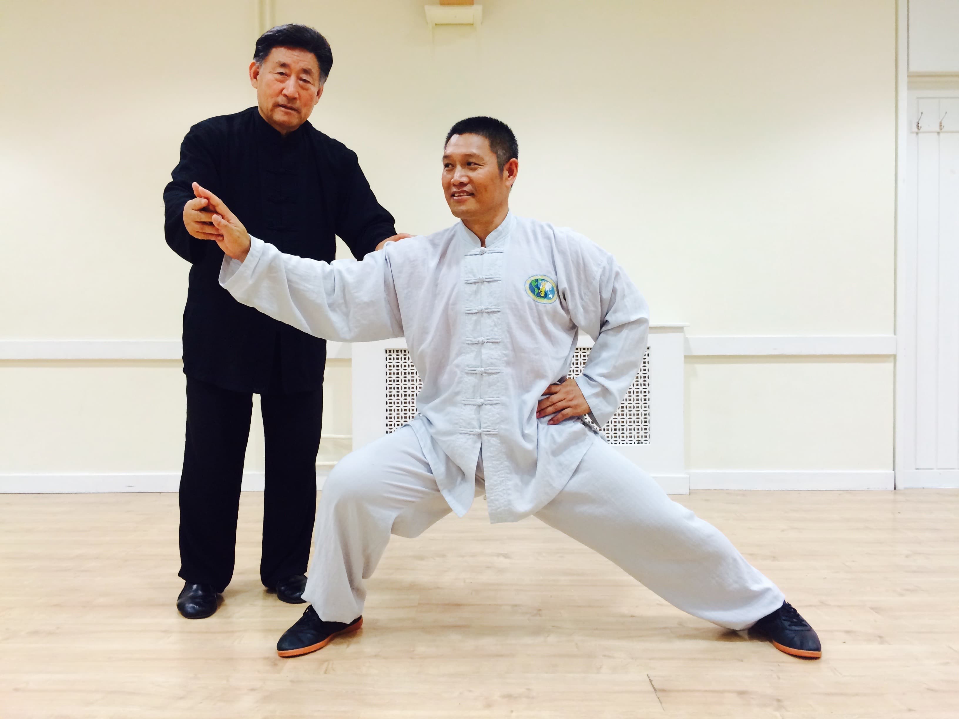 Grandmaster Chen Xiaowang correcting Master Liu's posture, 2015