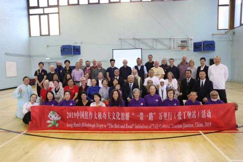 Group photograph of the Edinburgh event, the front row holding a red Jiaozuo Belt and Road banner