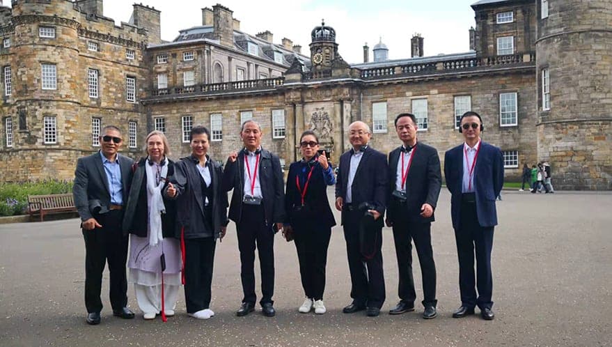 The Jiaozuo officials standing in a line in the forecourt of the Palace of Holyroodhouse, Edinburgh