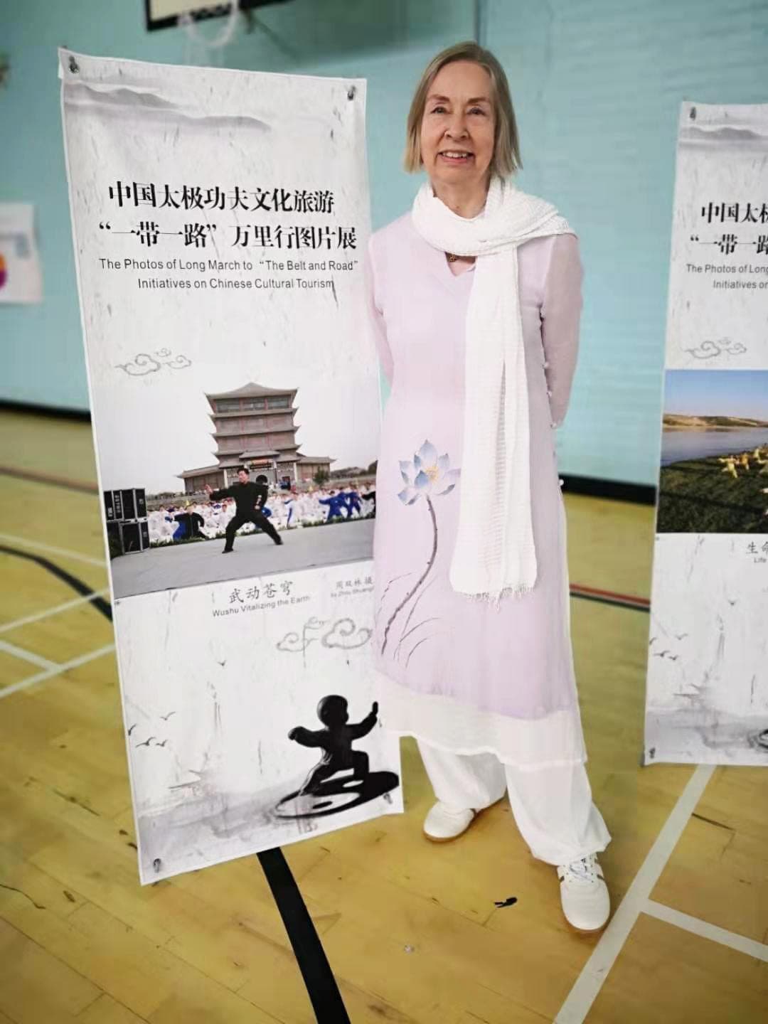 Chris Jones standing beside a Belt and Road Taiji poster in the Edinburgh University gym
