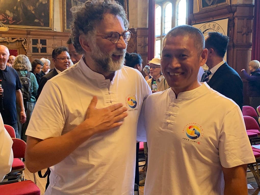 Craig Simmons and Shifu Liu Quanjun smiling side by side in the wood-panelled hall of Oxford Town Hall