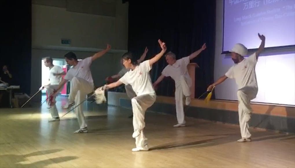 Tai Ji Circle students performing the Chen sword form on stage in London