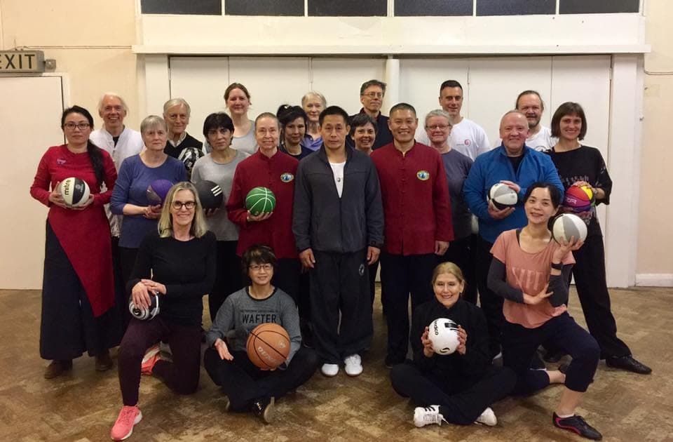 Group photo of the Taiji Ball workshop, participants holding coloured balls