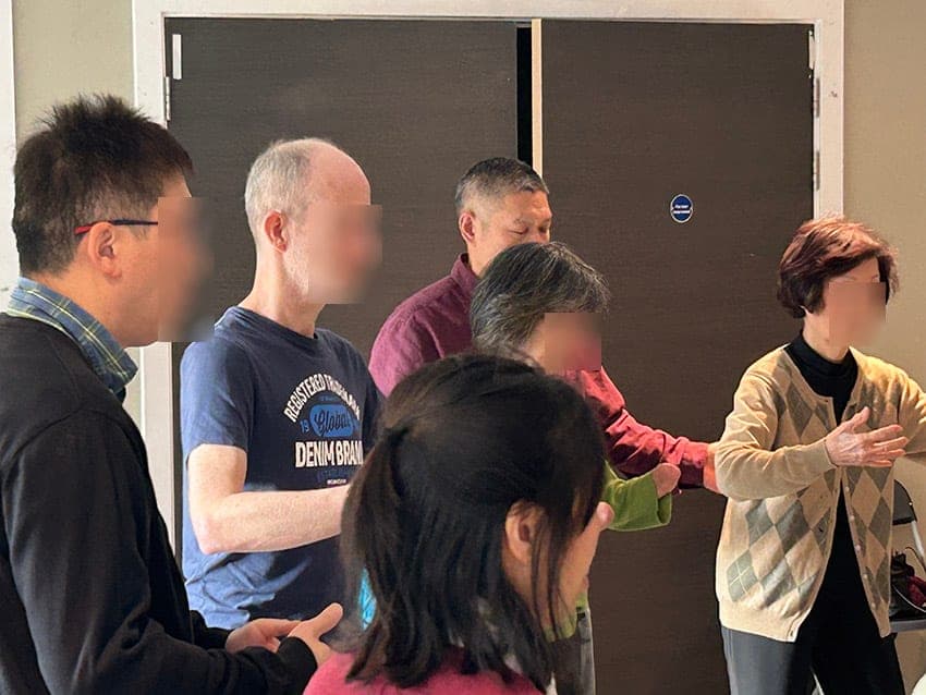 Shifu Liu working with students during standing practice