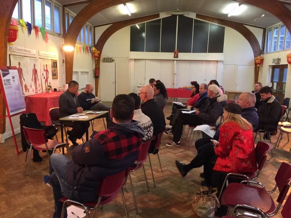 Students seated in rows for the 2018 AGM in a church hall decorated with red lanterns and bunting